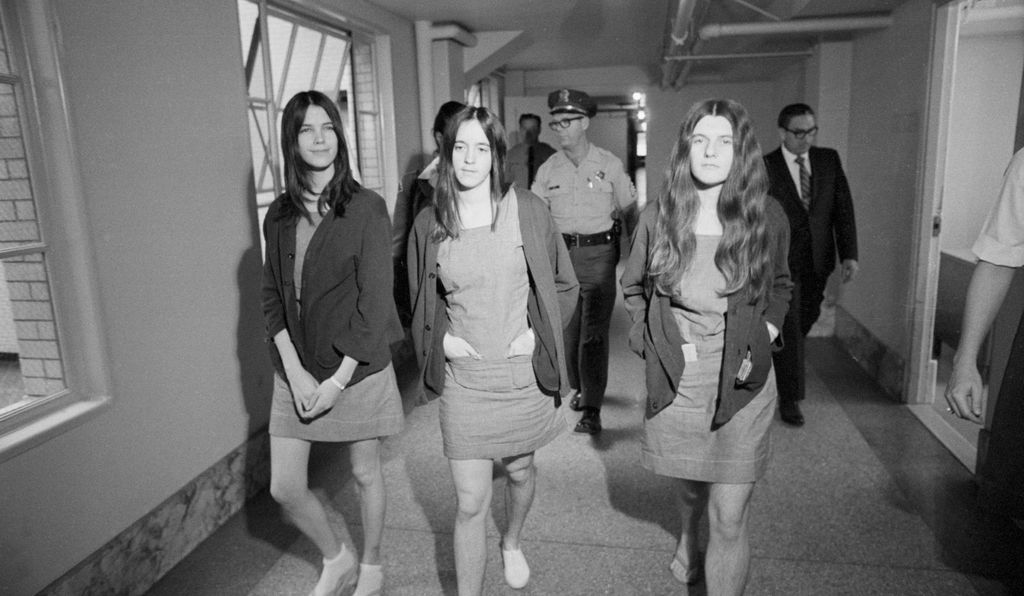 Leslie Van Houten, Susan Atkins, and Patricia Krenwinkel (left to right) walk from the jail section to the courtroom during the trial for their role in the Manson Family murders.